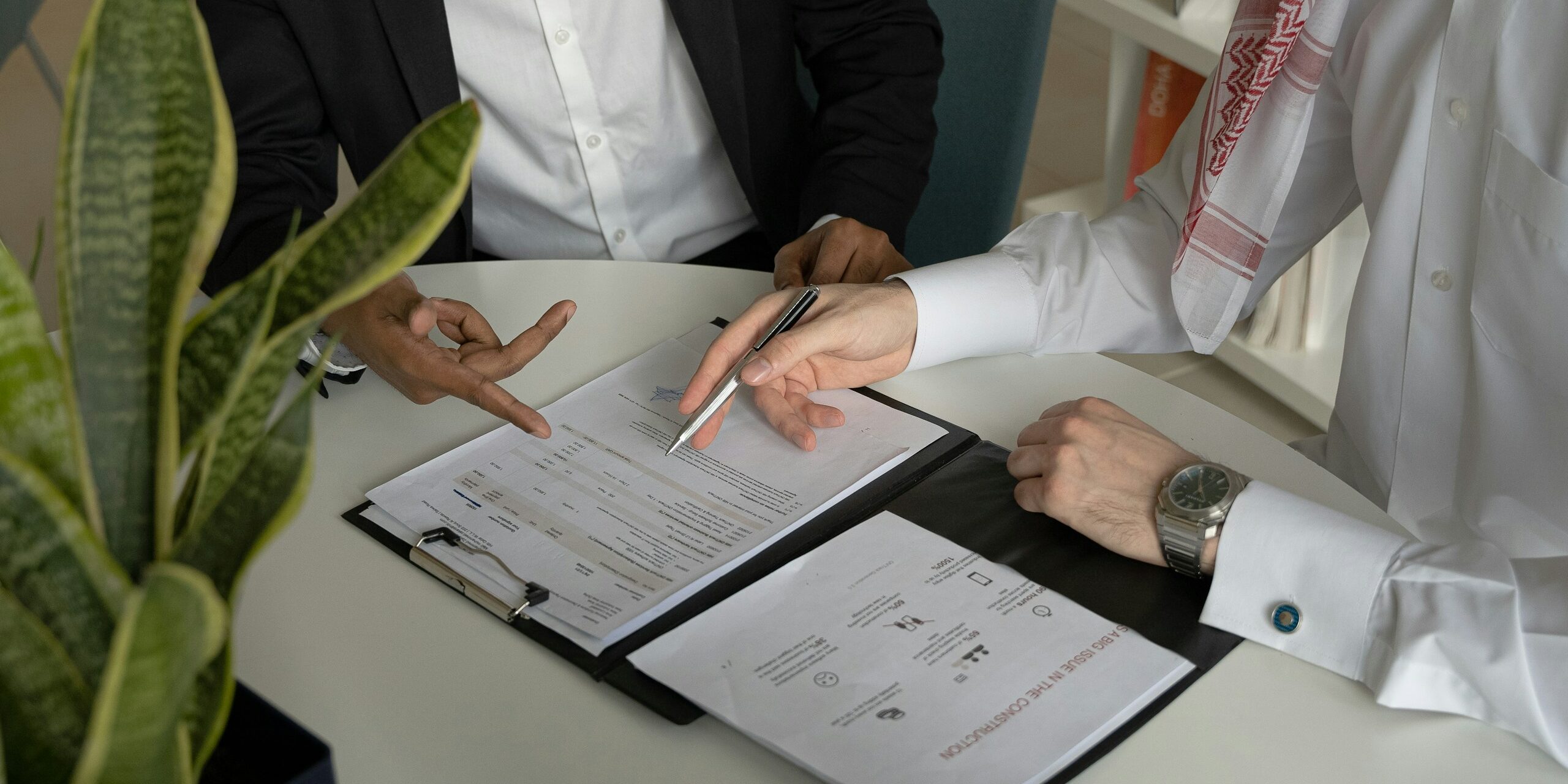 Two people going over a contract or results